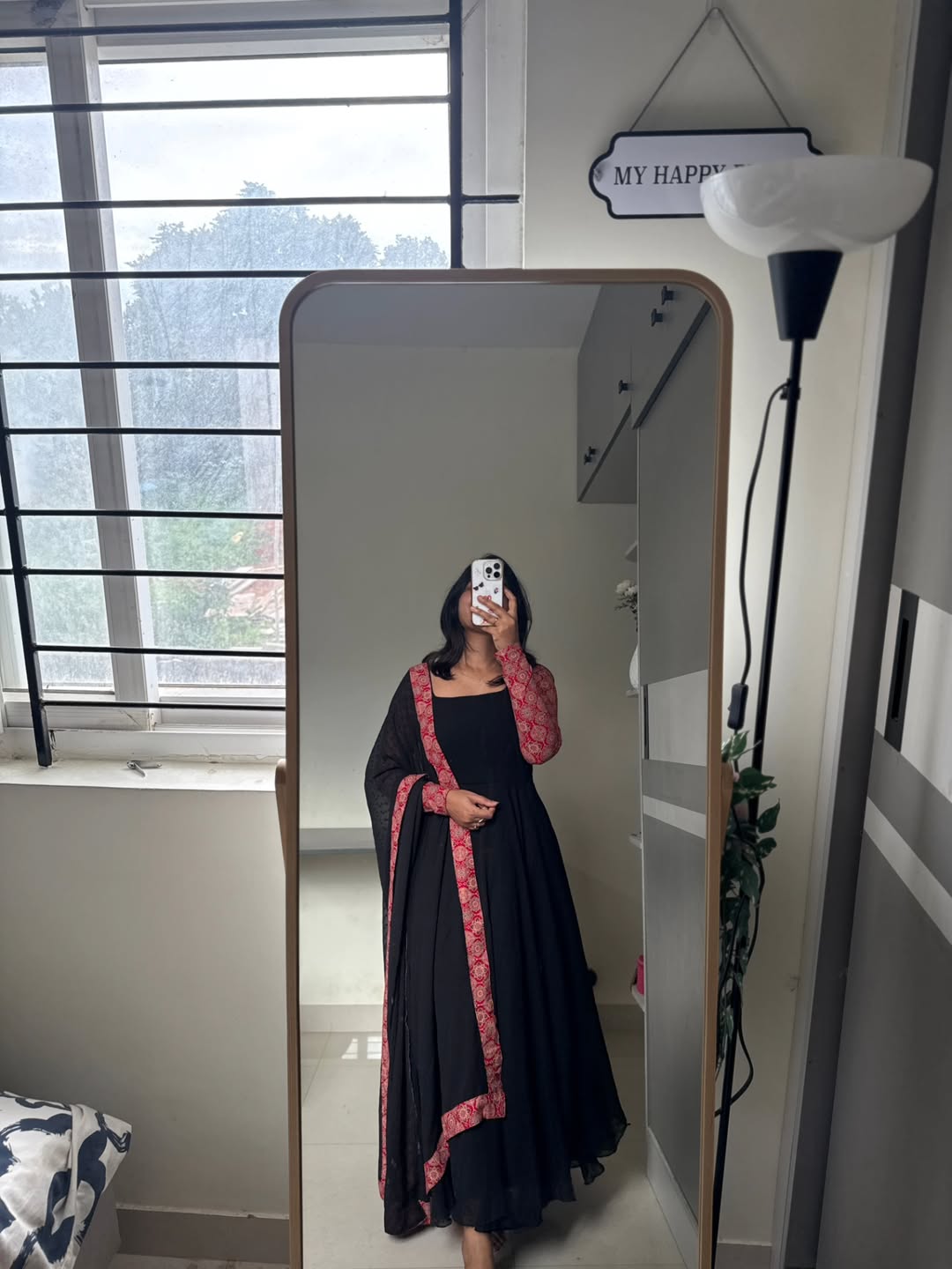 stunning portrait of a young woman exuding grace and poise in a traditional black Anarkali outfit.(JORJET)