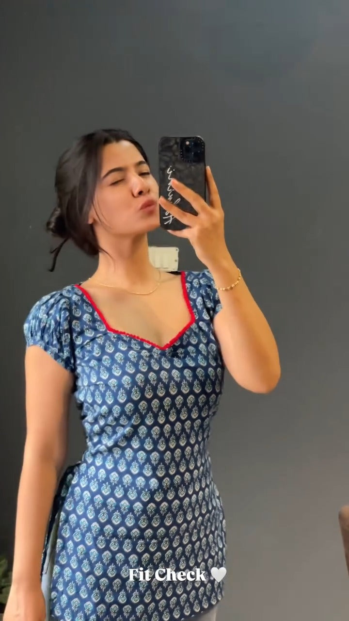 blue and white patterned kurti with a distinctive red border