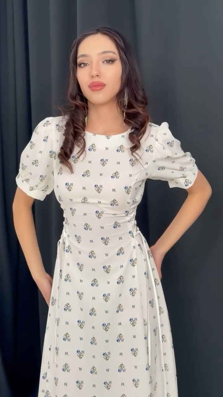 white midi dress with a blue floral print ( fabric is likely breathable, Poly rayon)