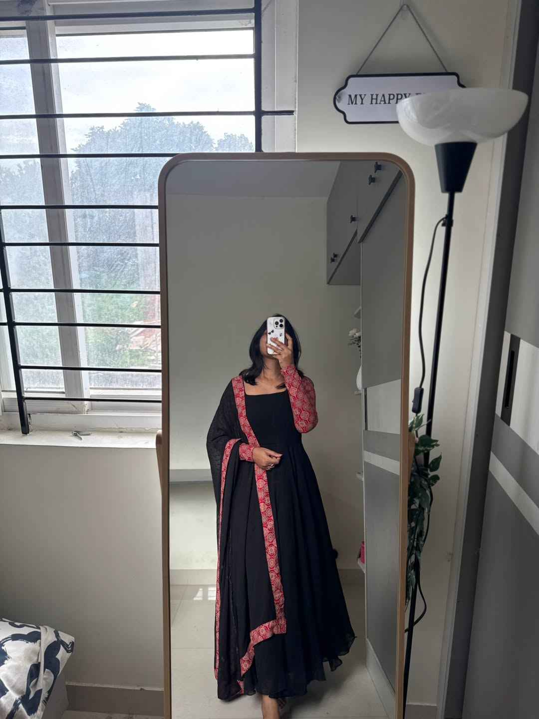 stunning portrait of a young woman exuding grace and poise in a traditional black Anarkali outfit.(JORJET)